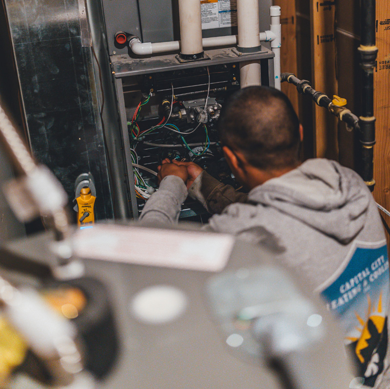 a man repairing a furnace